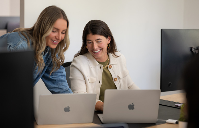 CFO Camille Fourrier collaborates with a colleague on the finance team